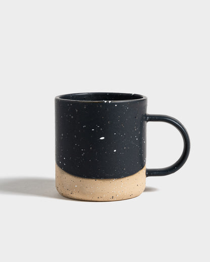 Black 8 oz. Stoneware Mug (Angle): Dark navy speckled glaze over unglazed natural stoneware base with handle