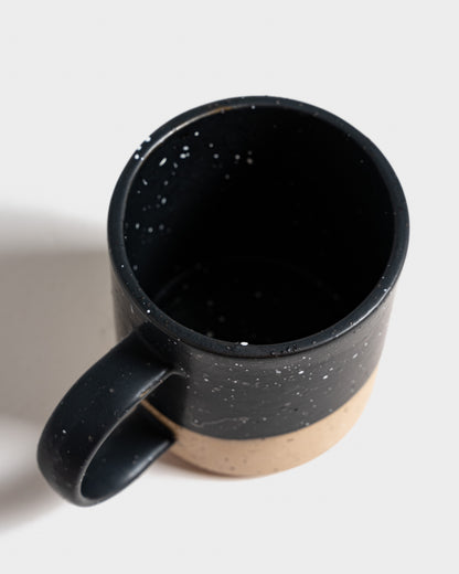 Black 8 oz. Stoneware Mug (Detail): Overhead view into matte black speckled interior; unglazed tan lower half visible