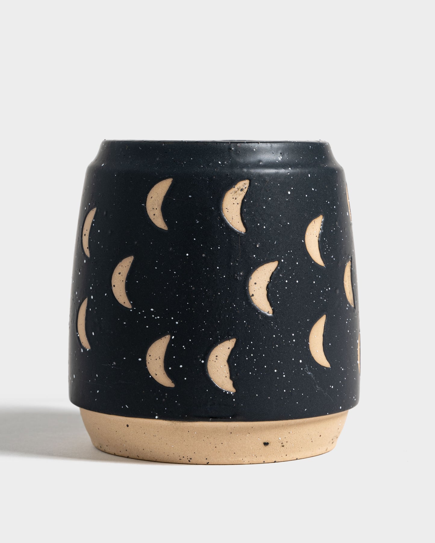 Nightfall Blue 16 oz. Stoneware Mug (Front): Dark navy speckled mug with carved crescent moon motifs and unglazed base