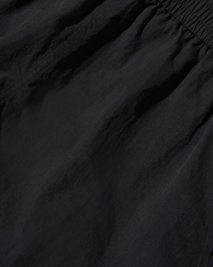 Black Recycled Sport Short (Detail): Close-up of black fabric with elastic waistband and subtle wrinkles