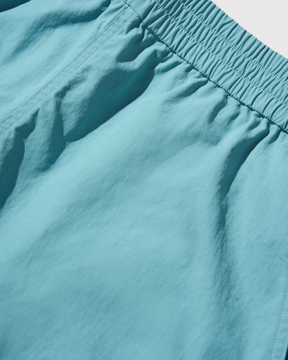 Teal Recycled Sport Short (Detail): Close-up of teal fabric with gathered elastic waistband and stitching detail