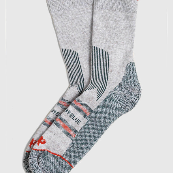 Green Bison Wool Trail Sock (Flat-lay): Pair of light grey crew socks with red cuff stripe and teal accents