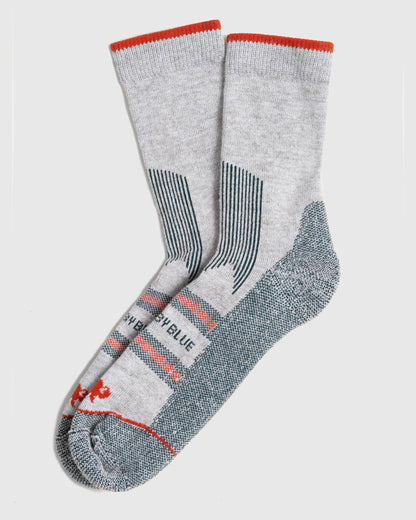 Green Bison Wool Trail Sock (Flat-lay): Pair of light grey crew socks with red cuff stripe and teal accents