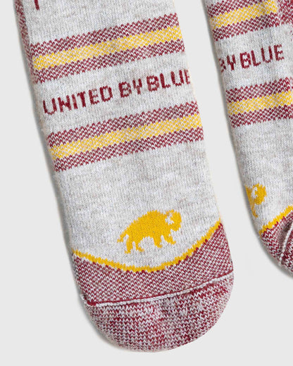 Red Bison Wool Trail Sock (Detail): Close-up of gray socks with burgundy stripes and yellow bison logo