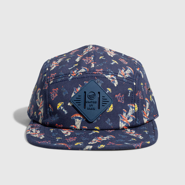 Navy Mushrooms Organic 5-Panel Hat (Front): Navy five-panel cap with mushroom print; diamond logo patch on front