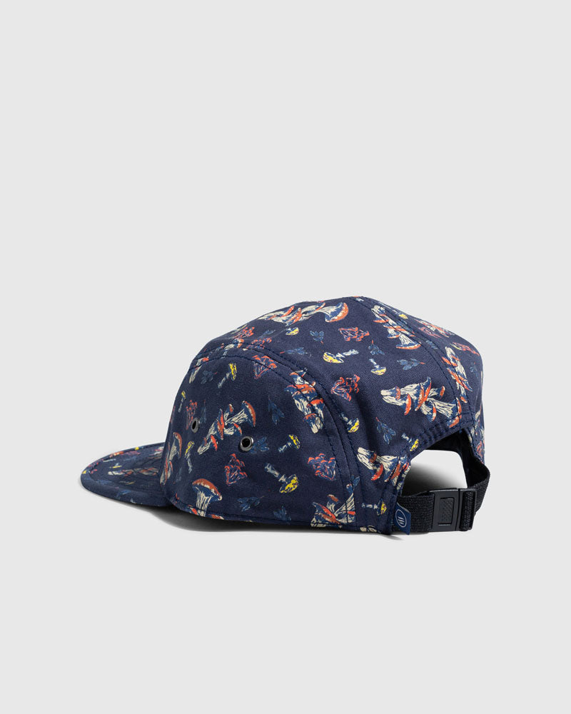 Navy Mushrooms Organic 5-Panel Hat (Angle): Navy five-panel cap with colorful mushroom print and black buckle strap