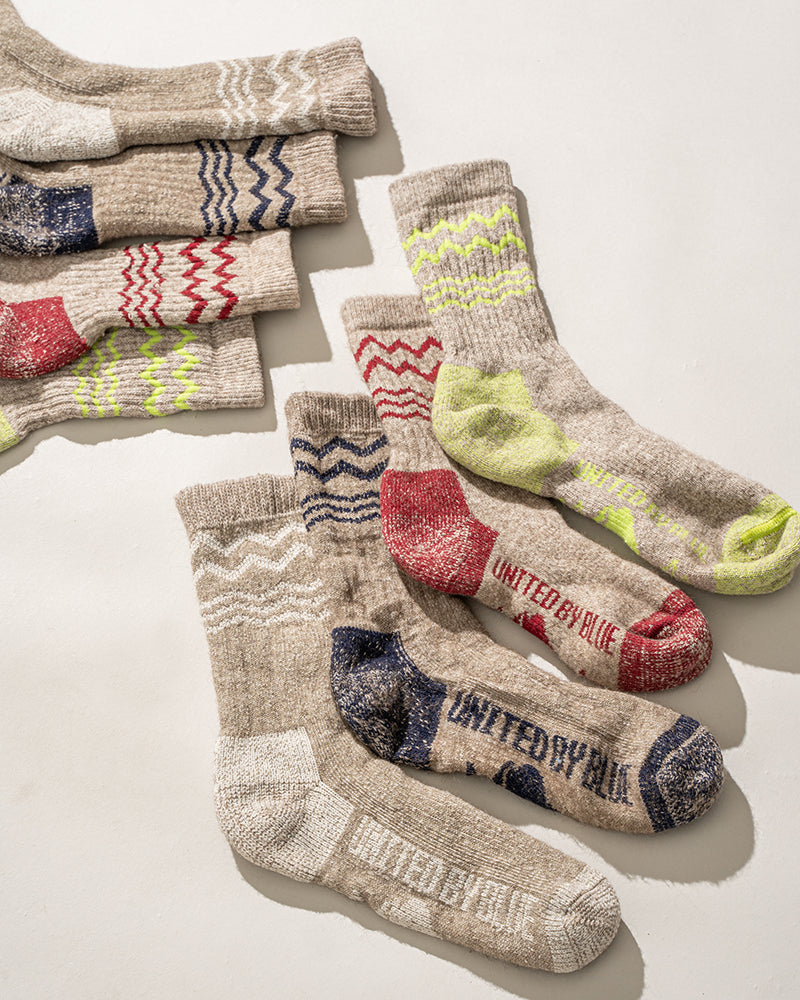 Red The Ultimate Bison Wool Sock (Flat-lay): Tan wool socks with red heel and toe, zigzag stripe accents