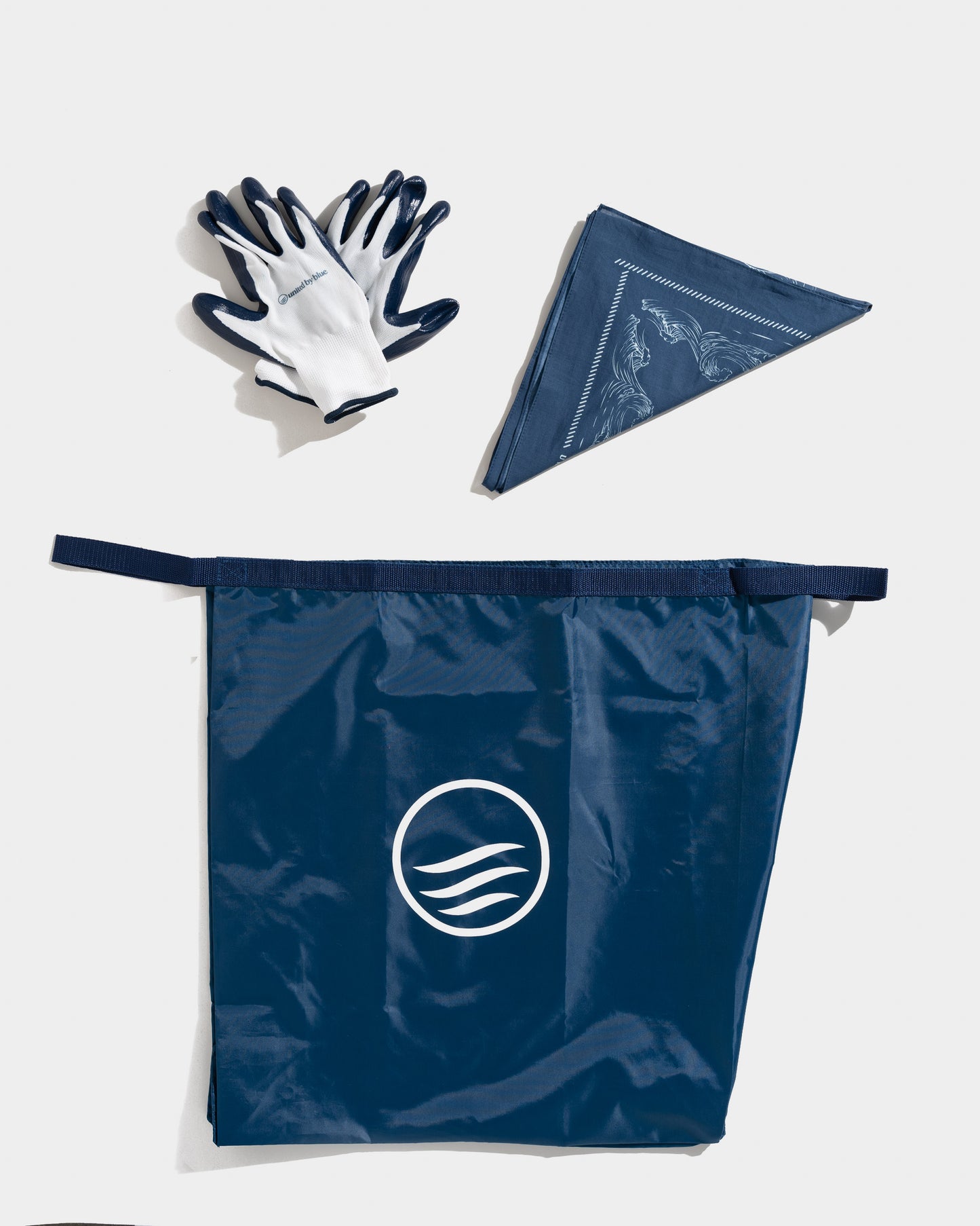 Navy Reusable DIY Cleanup Kit (Flat-lay): Navy cleanup bag with wave logo, work gloves, and folded bandana