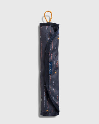 Navy The Straw Kit (Front): Rolled navy star-print case with yellow loop and blue brand label