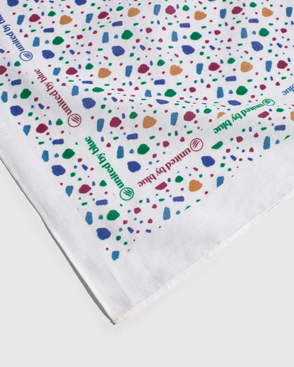 Egret Organic Bandana (Detail): White bandana with colorful terrazzo shapes and repeated brand logo text