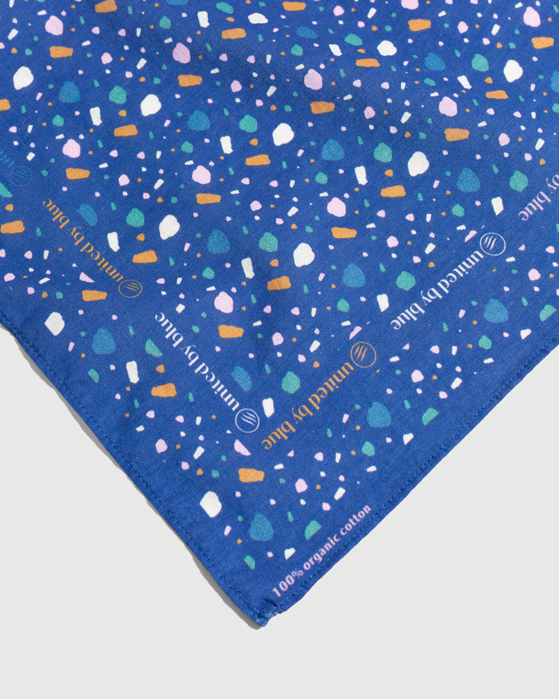 Lagoon Organic Bandana (Detail): Blue bandana with multicolor terrazzo shapes, United by Blue logo text border