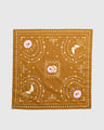 Smoky Ochre Organic Bandana (Flat-lay): Golden-brown bandana with celestial sun, moon, stars, and tree prints