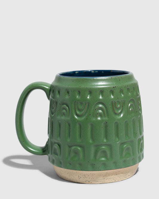 Pine 16 oz. Stoneware Mug (Angle): Forest green speckled ceramic mug with embossed arch pattern and navy interior