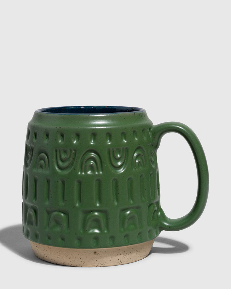 Pine 16 oz. Stoneware Mug (Angle): Forest green stoneware mug with embossed arch pattern and dark teal interior