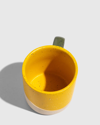 Butterscotch 8 oz. Stoneware Mug (Angle): Top-down view of yellow speckled mug with olive green handle