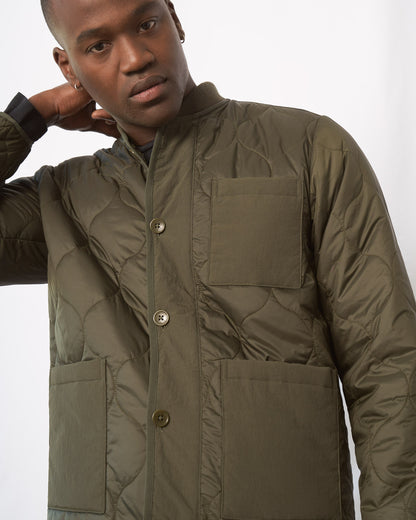 Forest Floor Bison Ultralight Liner Jacket (Detail): Close-up of olive quilted jacket with button placket and chest pocket
