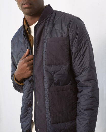 Night Sky Bison Ultralight Liner Jacket (Angle): Navy quilted bomber jacket open, chest and waist patch pockets visible