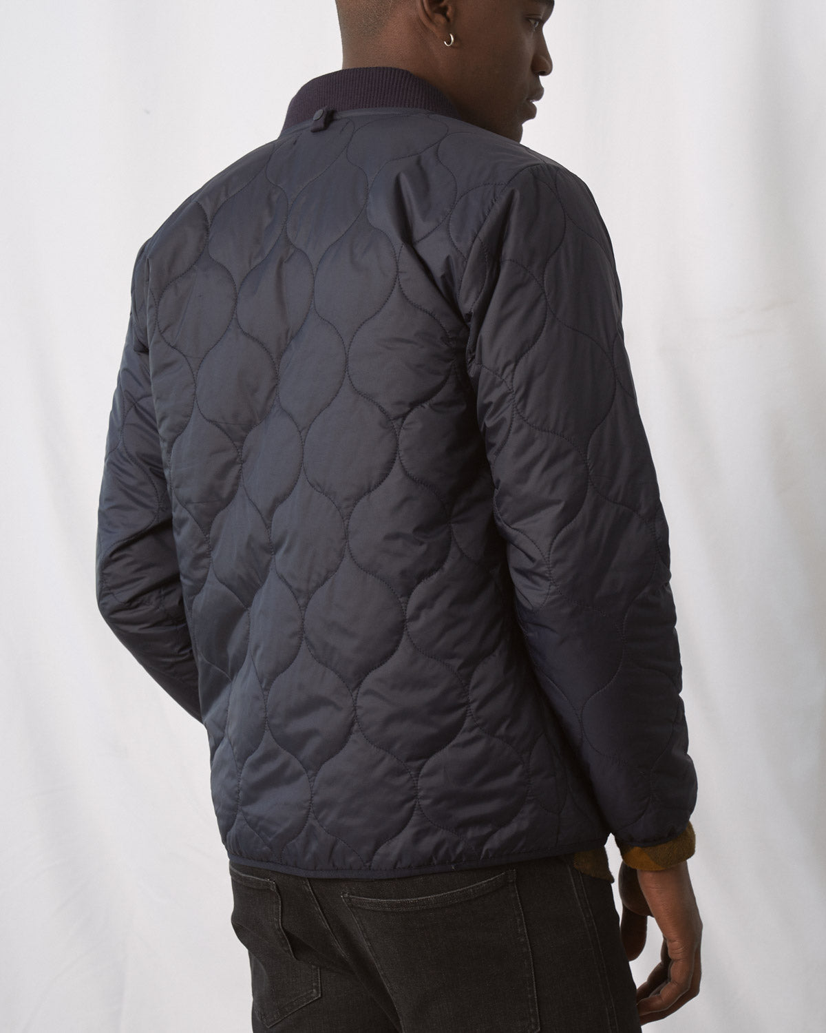 Night Sky Bison Ultralight Liner Jacket (Back): Dark navy quilted jacket with onion-shaped stitch pattern, ribbed collar