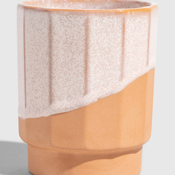 Foxglove 8 oz. Stackable Stoneware Tumbler (Angle): Ribbed stoneware cup with speckled pink glaze over natural terracotta base