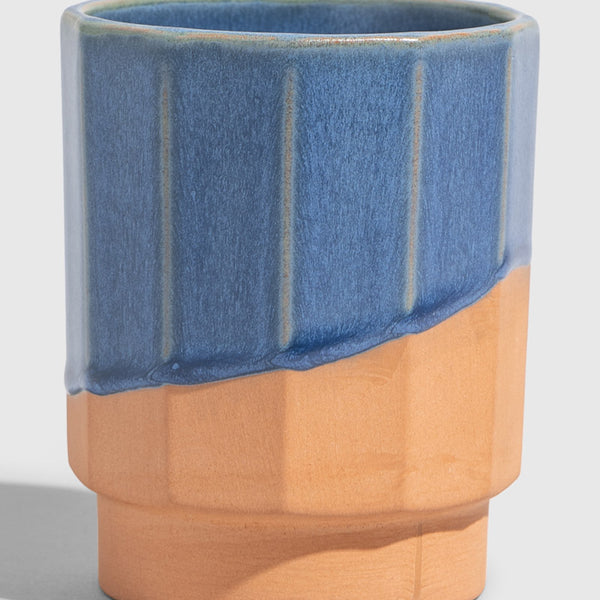 Cobalt 8 oz. Stackable Stoneware Tumbler (Angle): Faceted stoneware tumbler with blue glaze dipped over natural terracotta base