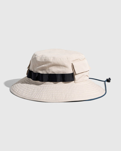 Bone Organic Bucket Stash Hat (Angle): Off-white boonie hat with black grosgrain band, side pockets, and chin cord