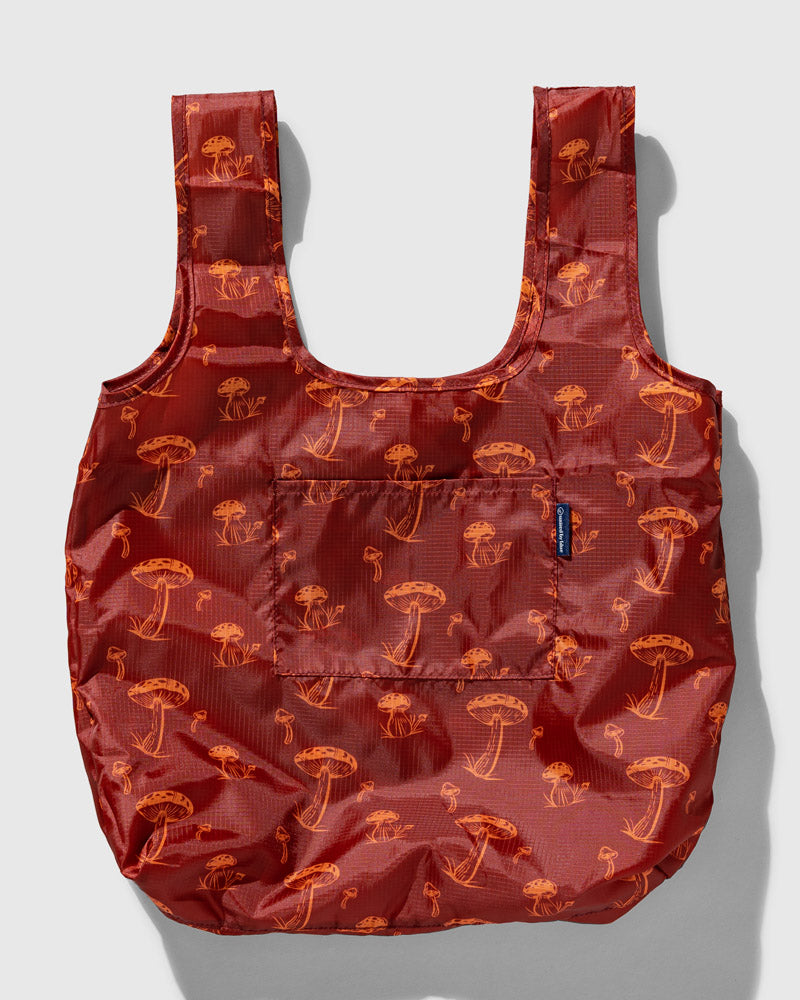 The Packable Tote (Front): Dark red ripstop tote with orange mushroom print, two straps, front pocket
