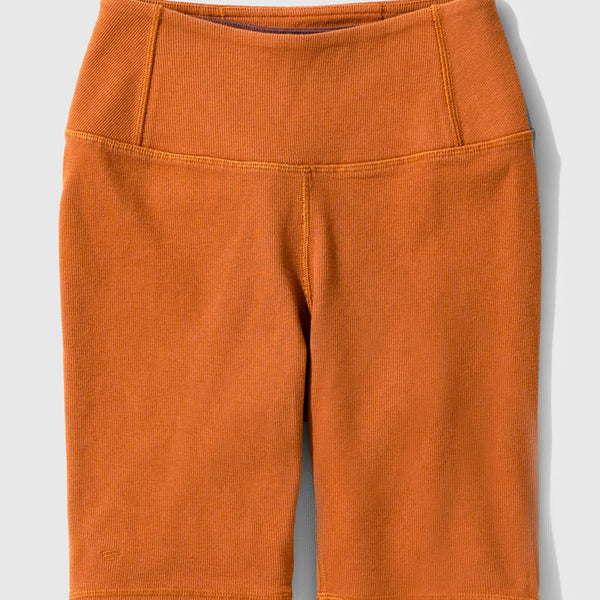 Cinnamon EcoKnit™ Ribbed Bike Short (Flat-lay): Burnt orange ribbed bike shorts with wide waistband and side pocket