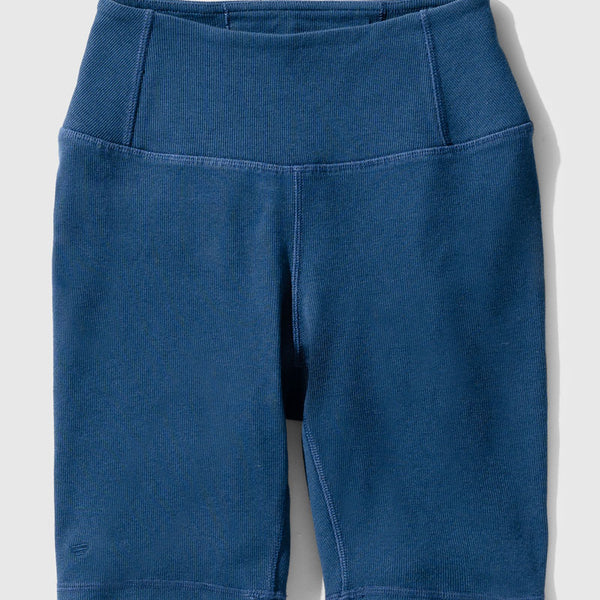 Midnight EcoKnit™ Ribbed Bike Short (Flat-lay): Dark blue ribbed bike shorts with wide waistband and side pocket
