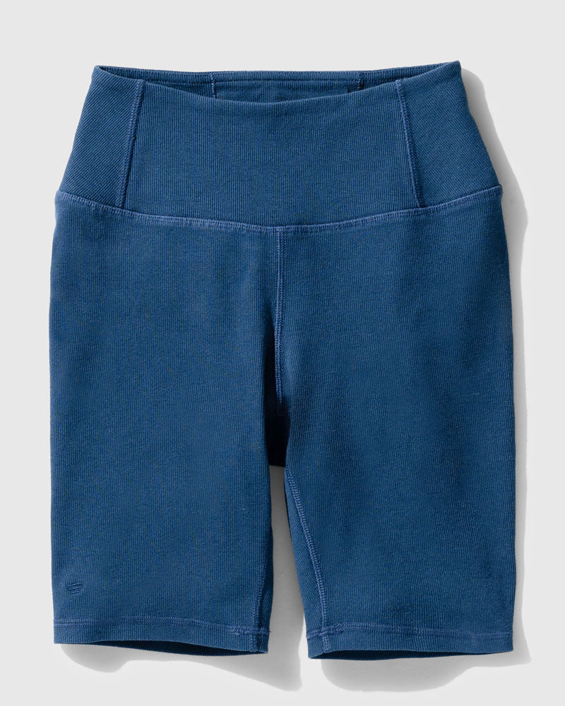 Midnight EcoKnit™ Ribbed Bike Short (Flat-lay): Dark blue ribbed bike shorts with wide waistband and side pocket