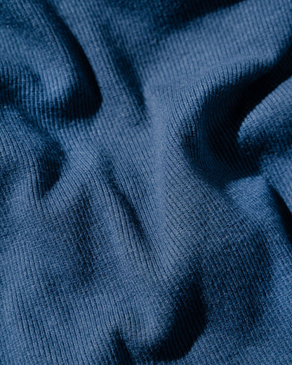Midnight EcoKnit™ Ribbed Bike Short (Detail): Close-up of ribbed navy blue fabric with soft folds and texture