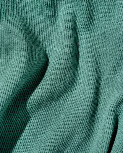 Jade EcoKnit™ Ribbed Bike Short (Detail): Close-up of teal ribbed knit fabric with soft draping folds