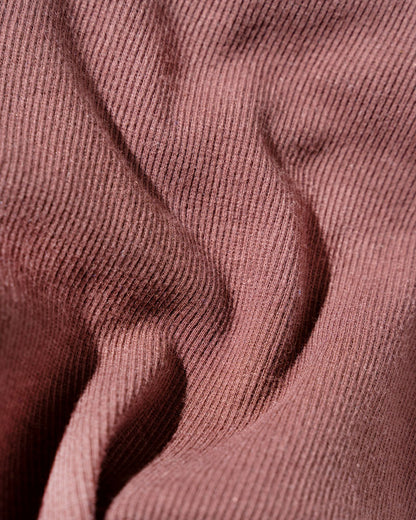 Chocolate EcoKnit™ Ribbed Bike Short (Detail): Close-up of dusty rose ribbed knit fabric with soft draping folds