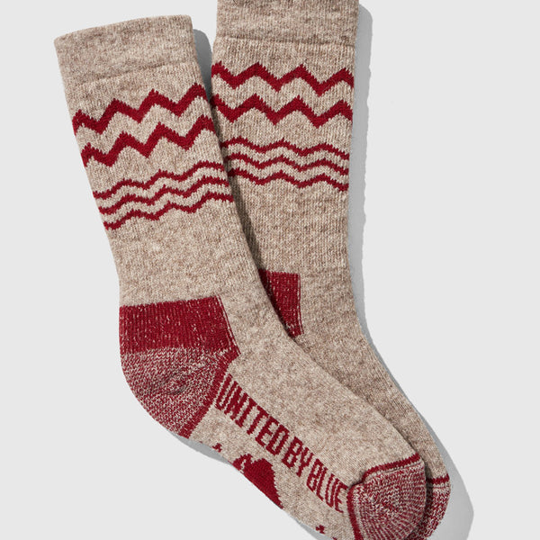 Red The Ultimate Bison Wool Sock (Flat-lay): Tan wool crew socks with red zigzag stripes and reinforced heel and toe