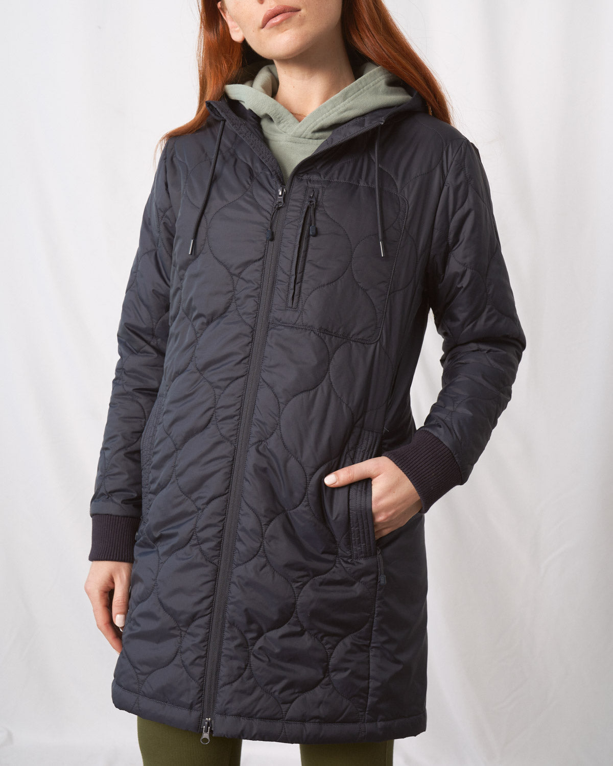 Night Sky Bison Ultralight Long Liner Jacket (Angle): Dark navy quilted long jacket with front zipper, chest pocket, ribbed cuffs