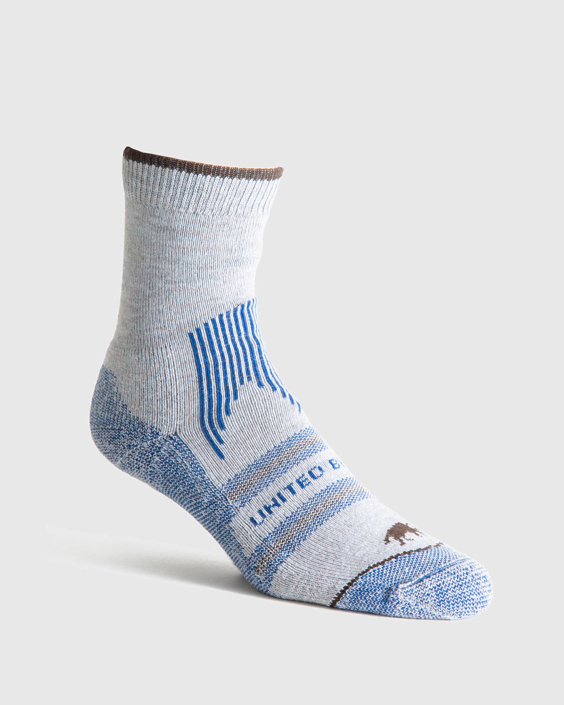 Blue Bison Wool Trail Sock (Angle): Light gray quarter-length sock with blue stripes, bear logo, brown trim