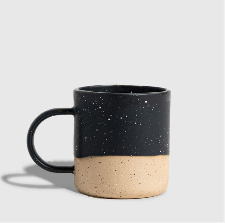 Black 8 oz. Stoneware Mug (Angle): Dark speckled glaze on upper half, unglazed natural clay base, round handle