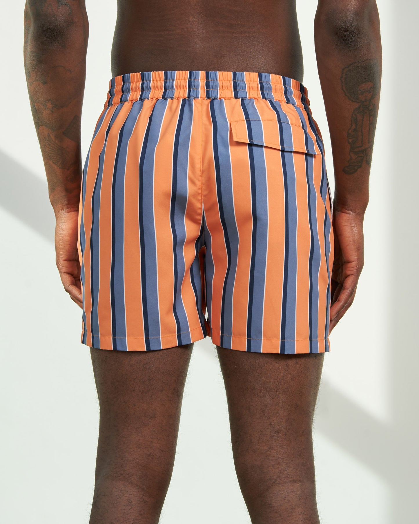 Orange Ochre Recycled Swim Trunk - 5" (Back): Back view showing orange and blue vertical stripes with rear flap pocket
