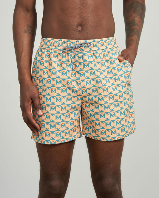 Buff Orange Recycled Swim Trunk - 5" (In-use): Peach swim trunks with teal geometric wave print, drawstring waist, side pocket