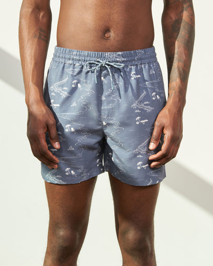 Stone Blue Recycled Swim Trunk - 5" (In-use): Blue-gray swim trunks with beach scene print and light blue drawstring