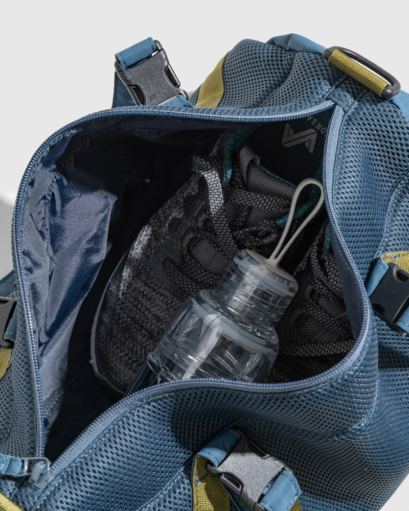 Blueberry (Re)active™ 16L Mini Duffle (Detail): Open interior of blue duffle showing mesh lining, shoes, and water bottle