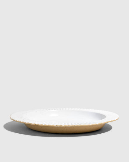 Eggshell Stoneware Stackable Plate (Side): Round ceramic plate with white glazed interior and ribbed rim, tan unglazed exterior