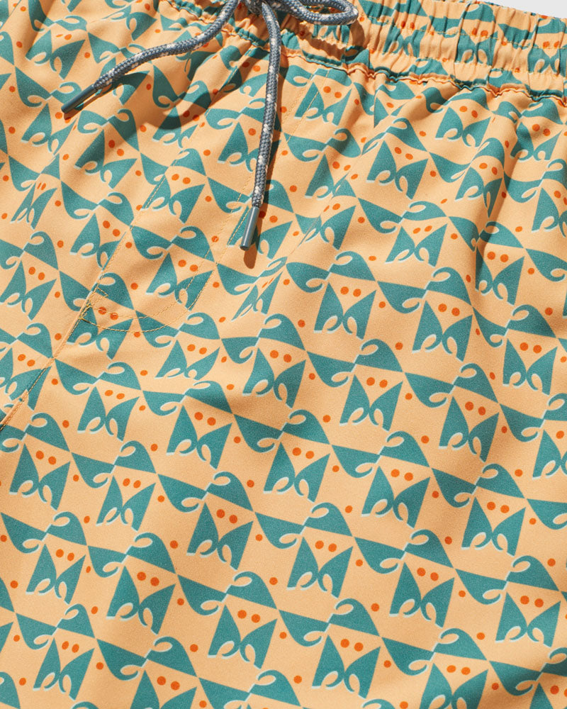 Buff Orange Recycled Swim Trunk - 5" (Detail): Close-up of peach fabric with teal geometric print and orange dot accents