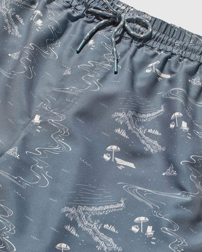 Stone Blue Recycled Swim Trunk - 5" (Detail): Close-up of slate blue fabric with white illustrated beach scene print and drawstring waistband