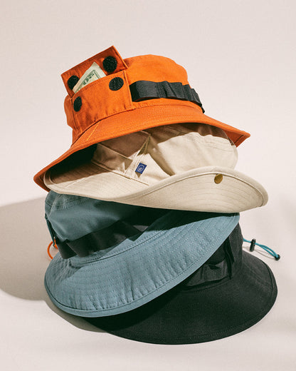 Bone Organic Bucket Stash Hat (Angle): Stack of four bucket hats in orange, cream, blue, and black