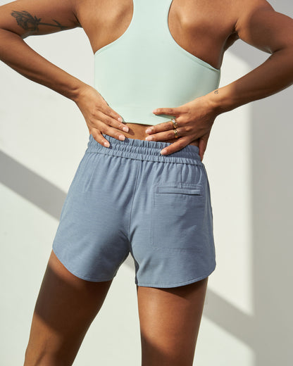 Stone Blue The Responsible Swim Short (Back): Back view of dusty blue shorts with elastic waistband and back pocket