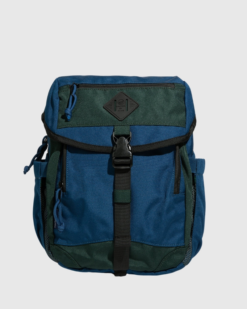 (R)evolution 9L Sidekick compact daypack in blue with green, shown from the front.